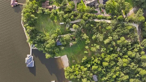 an aerial view of a house with a lake view