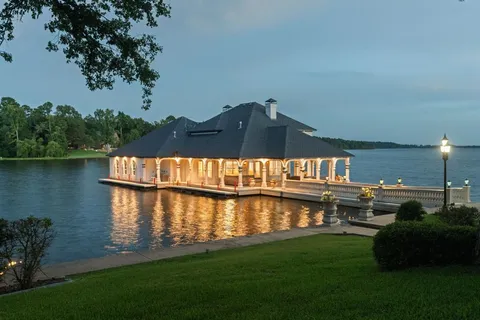 a view of swimming pool with outdoor seating and lake view