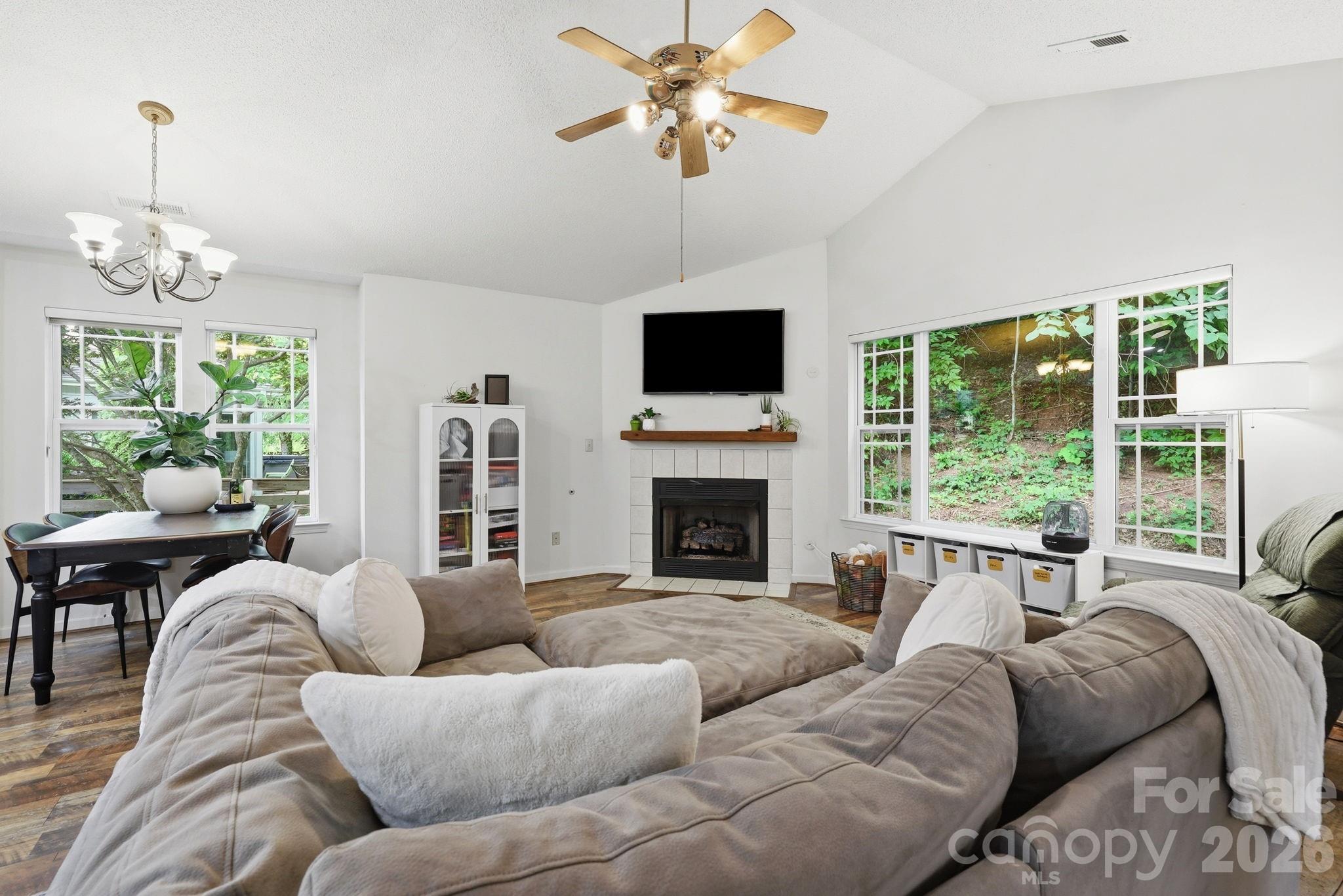 51 Sunview Circle Arden, NC 28704 - Photo 3 of 31 a living room with furniture a fireplace and a flat screen tv
