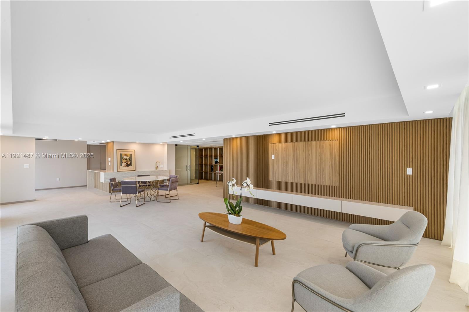 10155 Collins Avenue, Unit 202 Bal Harbour, FL 33154 - Photo 13 of 50 a living room with furniture and a lamp