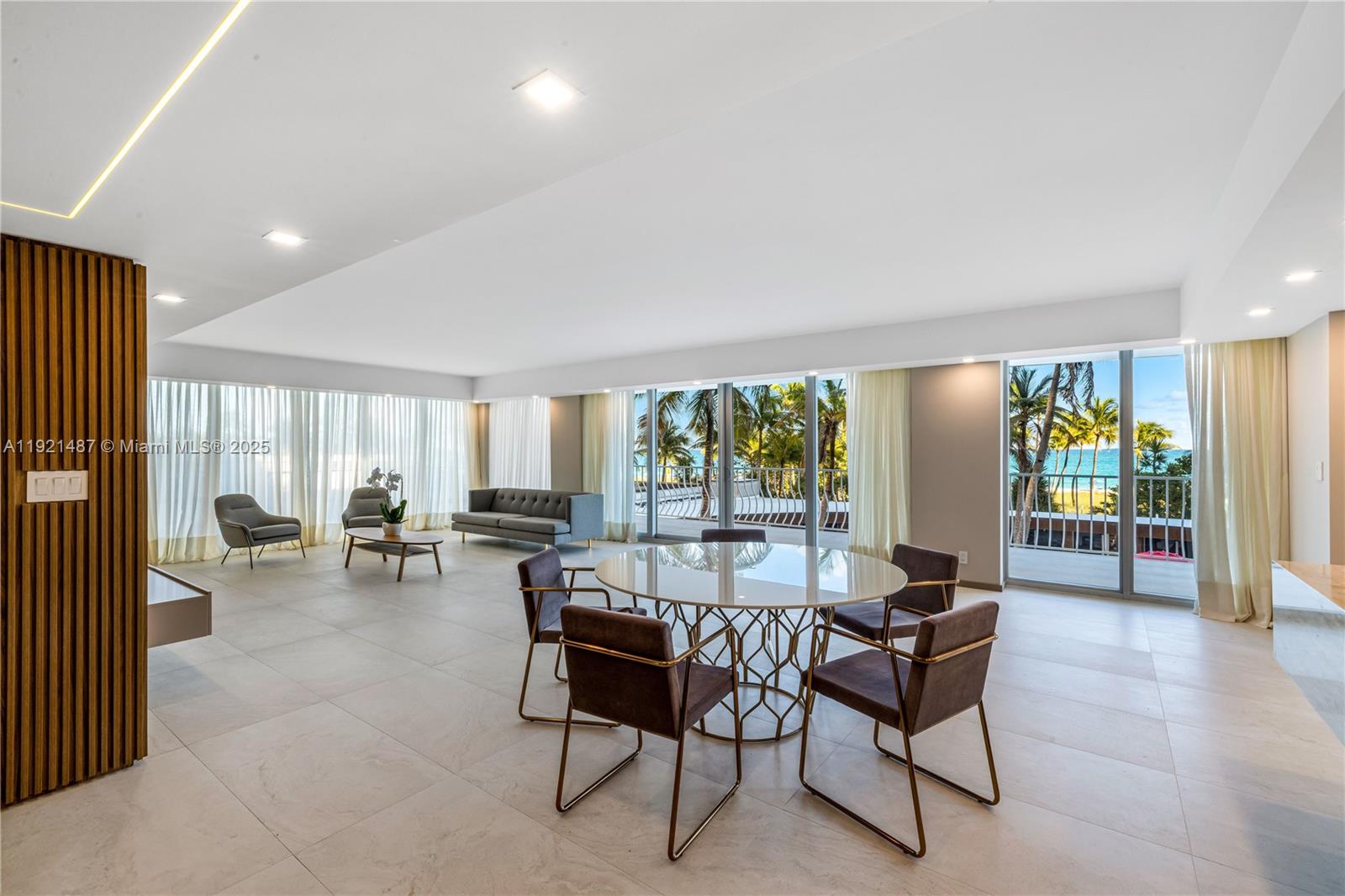 10155 Collins Avenue, Unit 202 Bal Harbour, FL 33154 - Photo 21 of 50 a living room with furniture and large windows