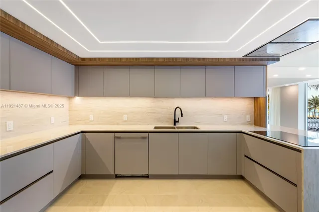a view of kitchen with stainless steel appliances granite countertop window and front door