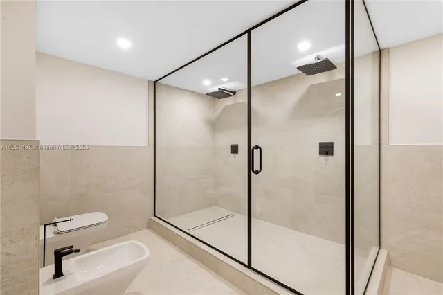 a bathroom with a double vanity sink toilet and shower