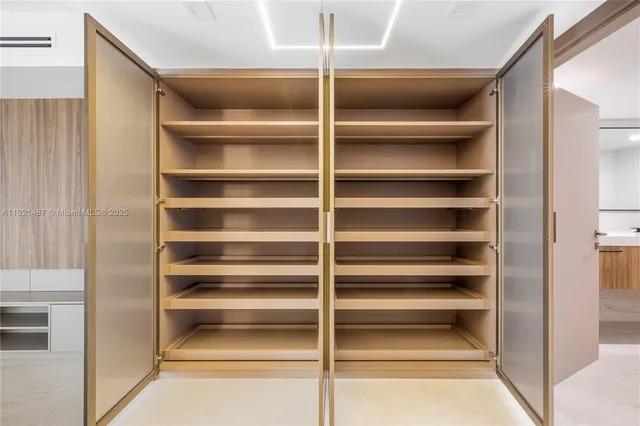 a view of a hallway with wooden shelves