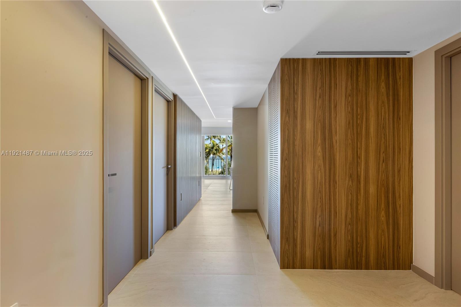 10155 Collins Avenue, Unit 202 Bal Harbour, FL 33154 - Photo 38 of 50 a view of a hallway with wooden shelves