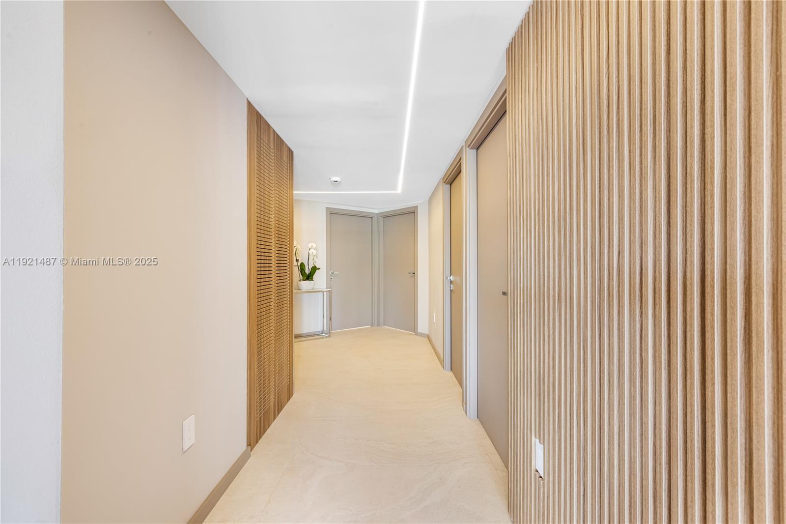 10155 Collins Avenue, Unit 202 Bal Harbour, FL 33154 - Photo 50 of 50 a view of a hallway with closet and wooden floor