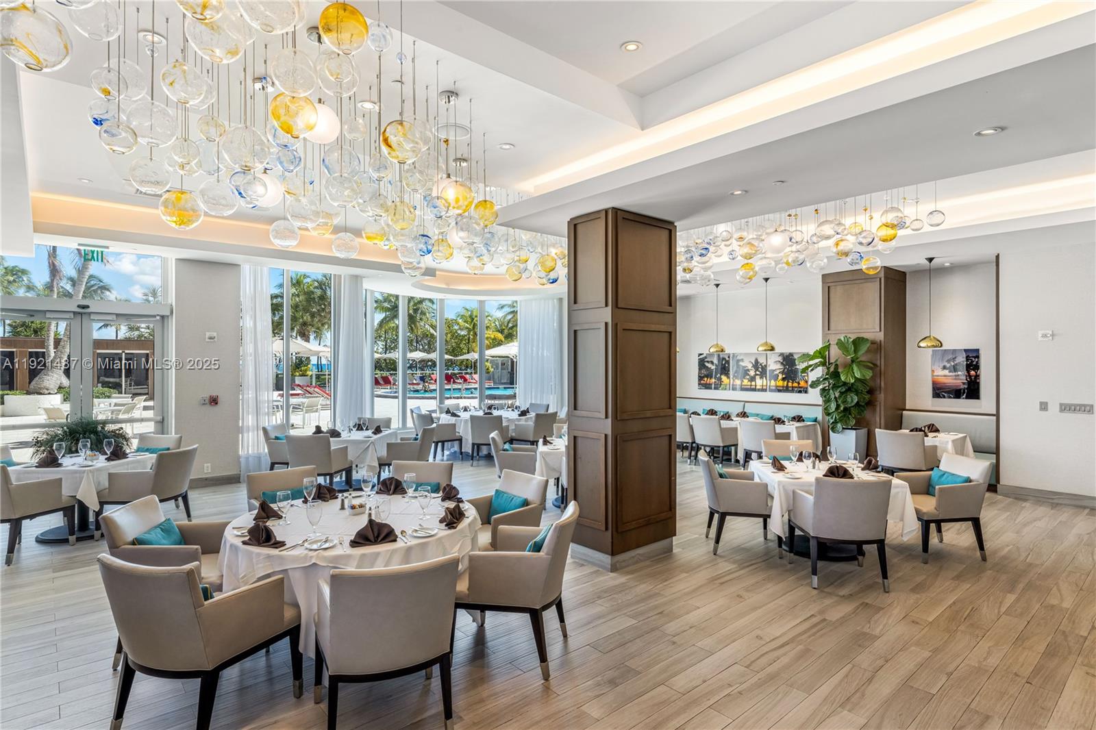 10155 Collins Avenue, Unit 202 Bal Harbour, FL 33154 - Photo 7 of 50 a living room with furniture and large windows