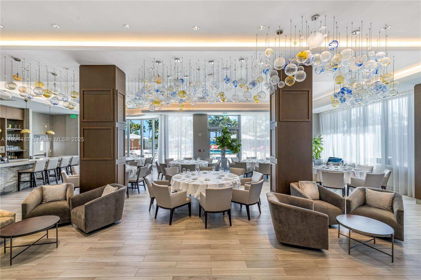 10155 Collins Avenue, Unit 202 Bal Harbour, FL 33154 - Photo 8 of 50 a living room with furniture and a large window