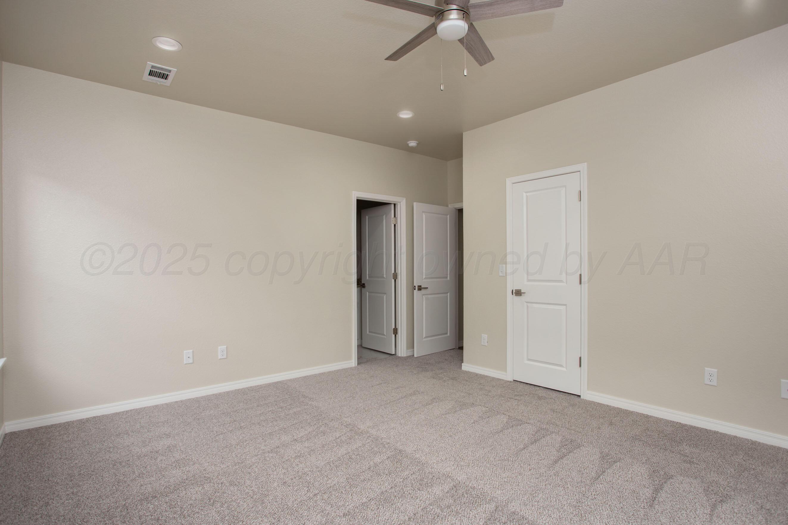 22111 Howard Draw Road Canyon, TX 79015 - Photo 13 of 25 an empty room with a ceiling fan and a window