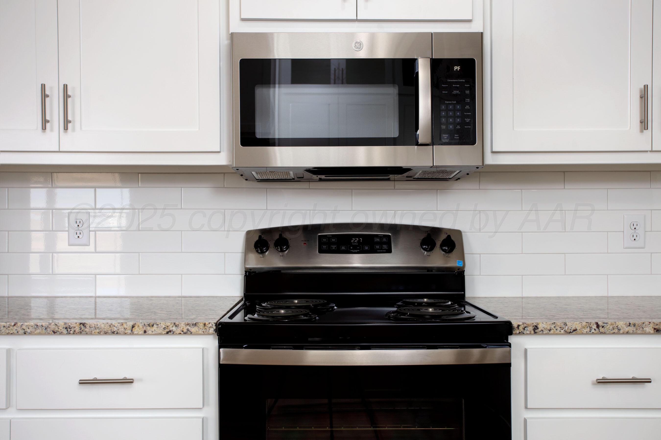 22111 Howard Draw Road Canyon, TX 79015 - Photo 7 of 25 a stove top oven sitting inside of a kitchen