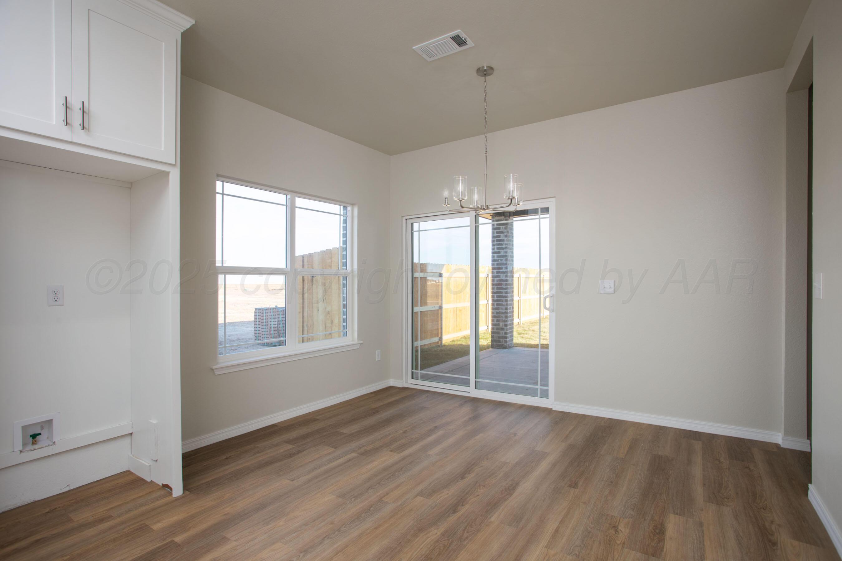 22111 Howard Draw Road Canyon, TX 79015 - Photo 9 of 25 an empty room with wooden floor and windows