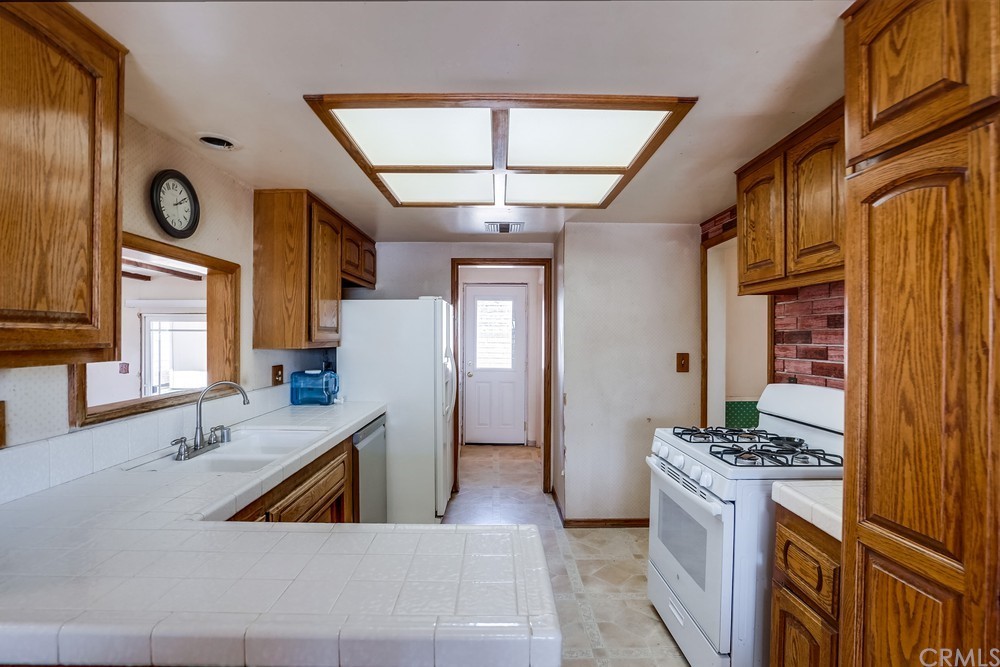 612 Lyford Drive La Verne, CA 91750 - Photo 13 of 44 a kitchen with stainless steel appliances granite countertop a sink a stove and a refrigerator