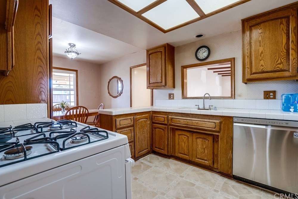 612 Lyford Drive La Verne, CA 91750 - Photo 15 of 44 a kitchen with stainless steel appliances a stove a sink and a refrigerator