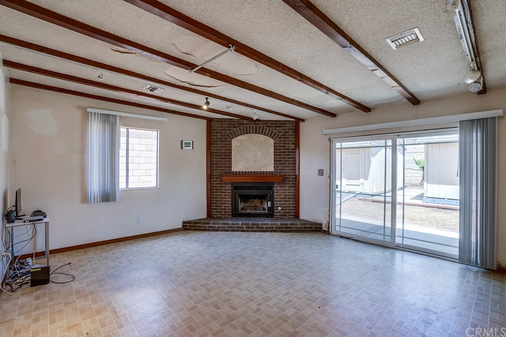 612 Lyford Drive La Verne, CA 91750 - Photo 17 of 44 a view of an empty room with a fireplace and a window