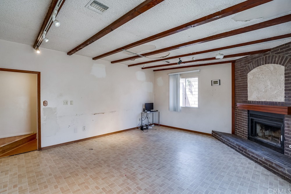 612 Lyford Drive La Verne, CA 91750 - Photo 18 of 44 a view of an empty room with a fireplace and a window