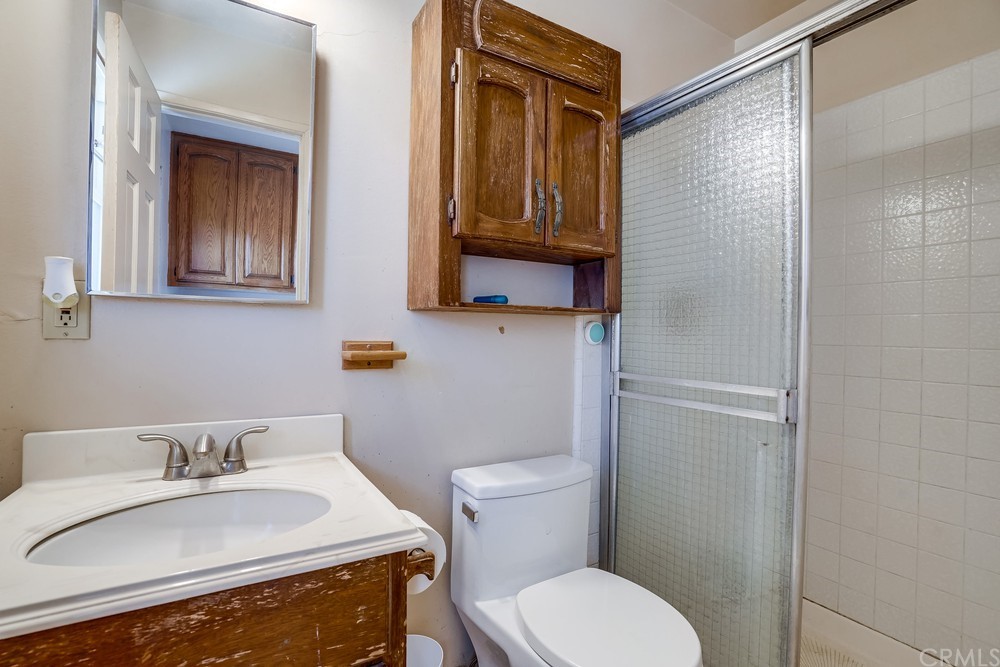 612 Lyford Drive La Verne, CA 91750 - Photo 22 of 44 a bathroom with a granite countertop toilet sink and mirror