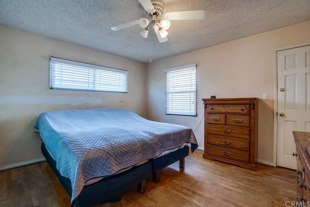612 Lyford Drive La Verne, CA 91750 - Photo 29 of 44 a bedroom with a bed a dresser and a chandelier