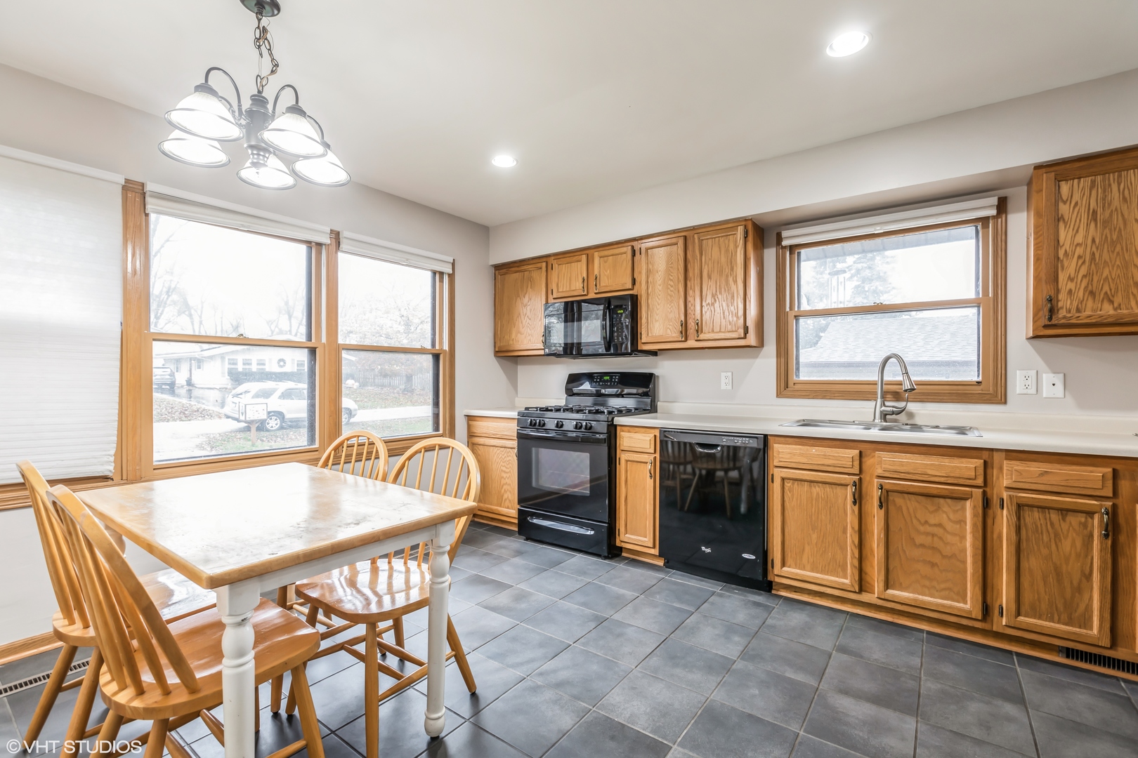 5 Hunters Path Lake In The Hills, IL 60156 - Photo 5 of 20 a kitchen with stainless steel appliances granite countertop a stove top oven a sink dishwasher a dining table and chairs with wooden floor