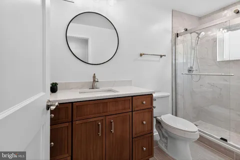 a bathroom with a sink mirror toilet and shower