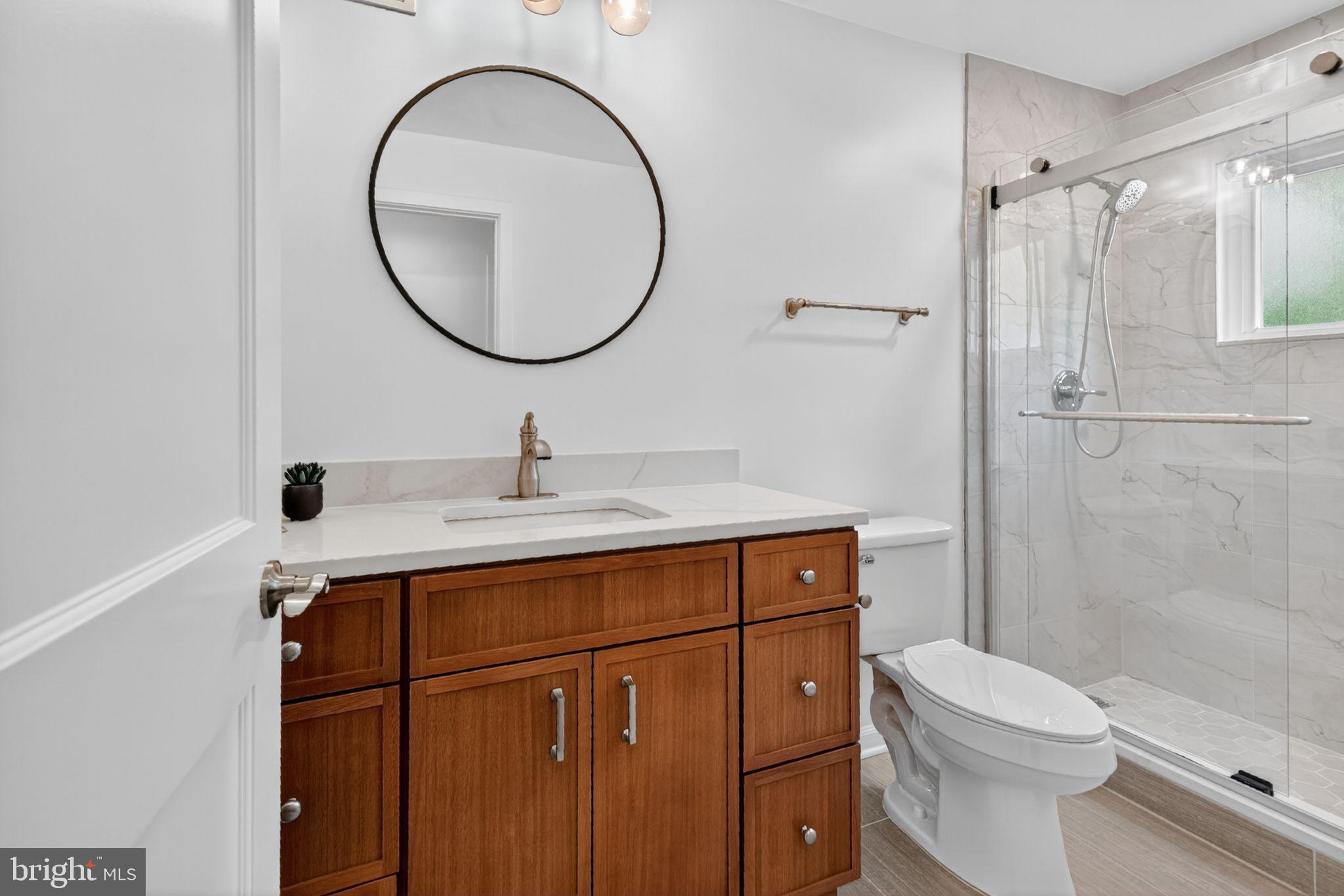 20 Hillside Road Greenbelt, MD 20770 - Photo 15 of 22 a bathroom with a sink mirror toilet and shower