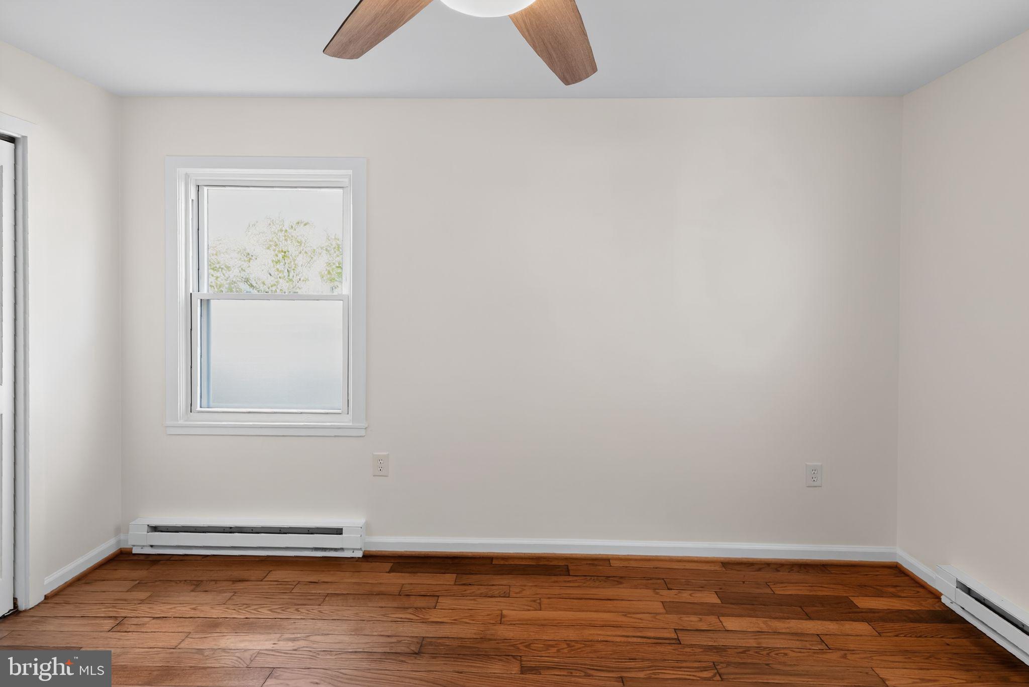 20 Hillside Road Greenbelt, MD 20770 - Photo 10 of 22 a view of an empty room with wooden floor and a window