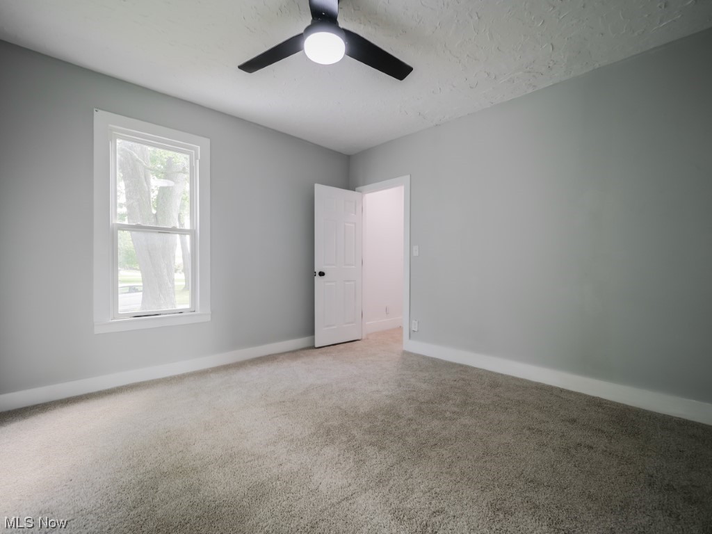 39330 Chestnut Ridge Road Elyria, OH 44035 - Photo 14 of 32 Carpeted spare room with a textured ceiling and ceiling fan
