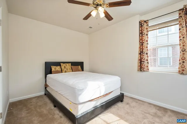 a bed sitting in a bedroom next to a window