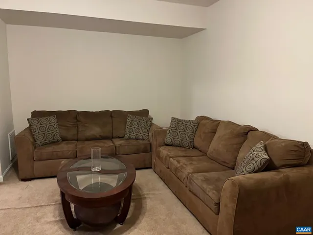 a living room with furniture a couch and a window