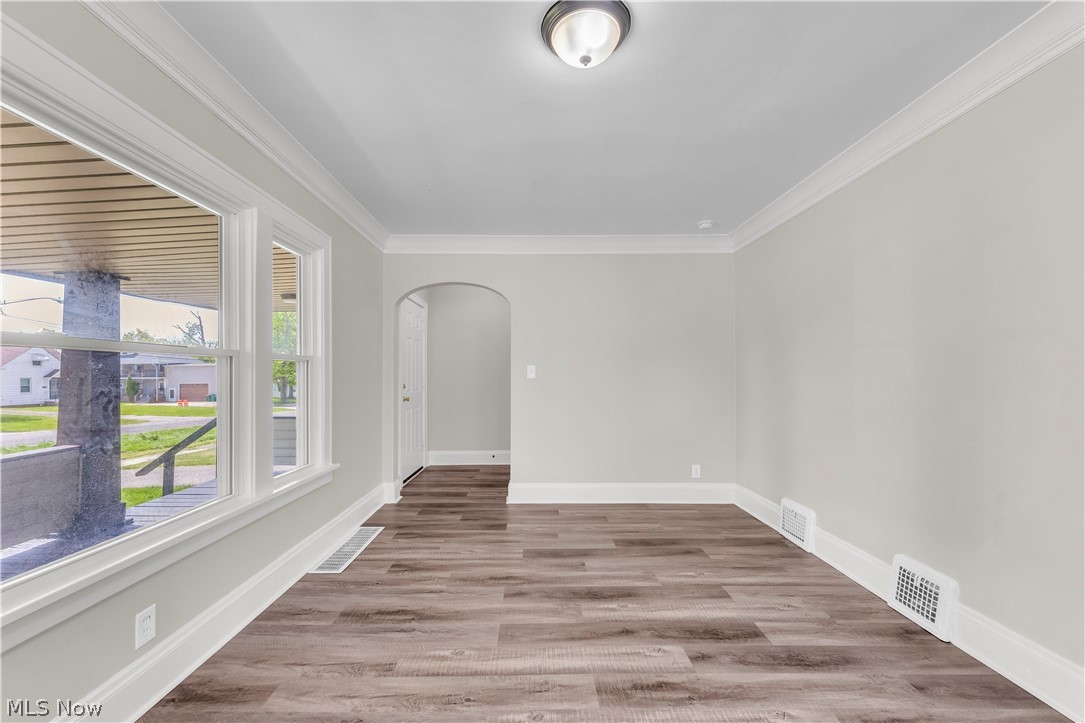 18123 McCracken Road Maple Heights, OH 44137 - Photo 9 of 27 Spacious room featuring wood-finish flooring, crisp white trim, and crown molding
