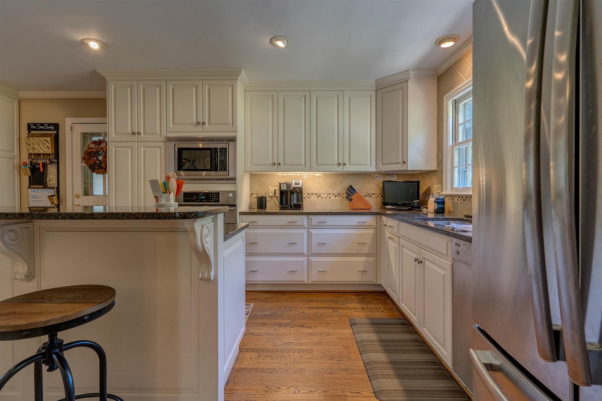 3009 Burnleigh Road Southwest Roanoke, VA 24014 - Photo 23 of 59 a kitchen with stainless steel appliances granite countertop a refrigerator sink and cabinets