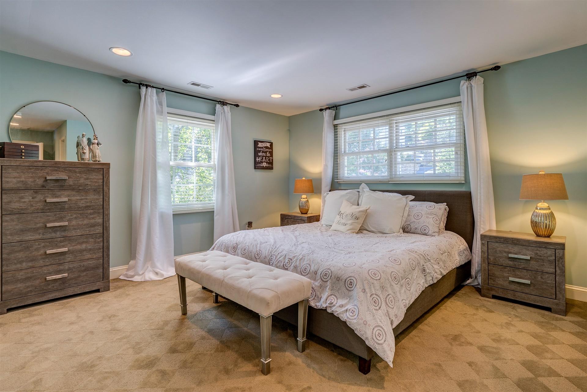 3009 Burnleigh Road Southwest Roanoke, VA 24014 - Photo 42 of 59 a spacious bedroom with a bed a dresser and a window