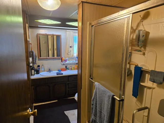 a bathroom with a sink vanity mirror and toilet
