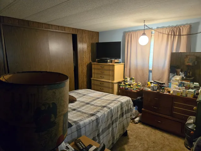 a bedroom with a bed and a mirror