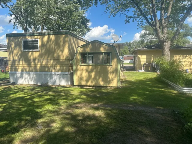 a backyard of a house with table and chairs