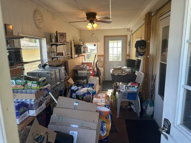 a dining room with furniture a chandelier and a window