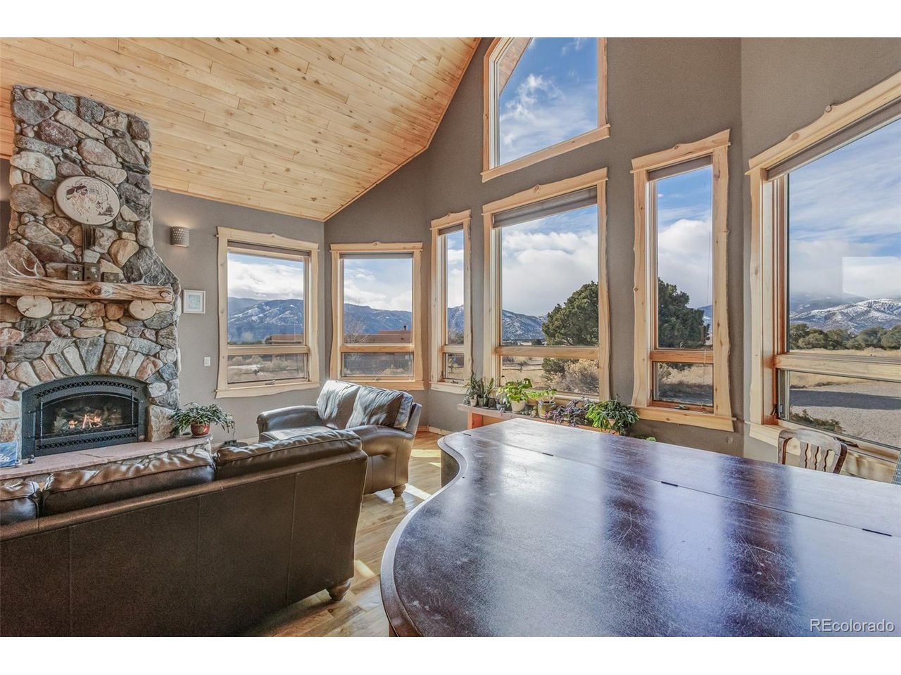 11677 Saddle Ridge Court Salida, CO 81201 - Photo 13 of 45 a living room with furniture large windows and fireplace