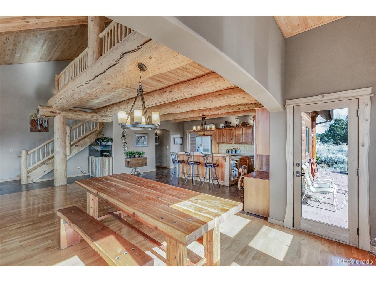 11677 Saddle Ridge Court Salida, CO 81201 - Photo 16 of 45 a room with lots of wooden furniture and glass door