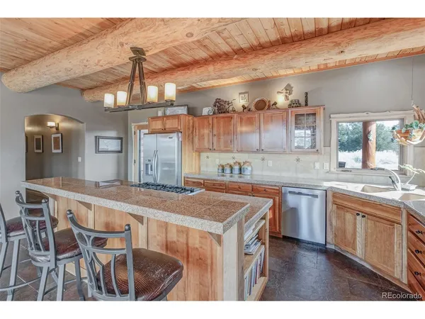 a kitchen with cabinets and wooden floor