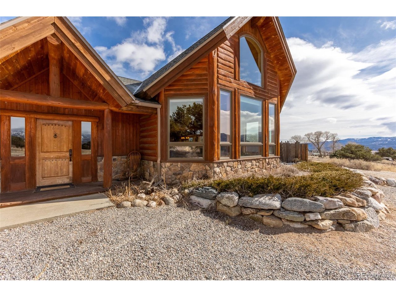 11677 Saddle Ridge Court Salida, CO 81201 - Photo 2 of 45 a very nice looking house with a large window and potted plants