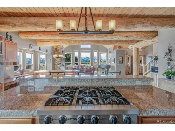a view of a living room and kitchen area