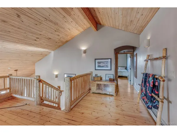 a view of a livingroom with furniture and staircase