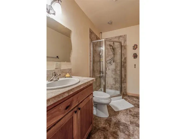 a bathroom with a sink toilet and shower