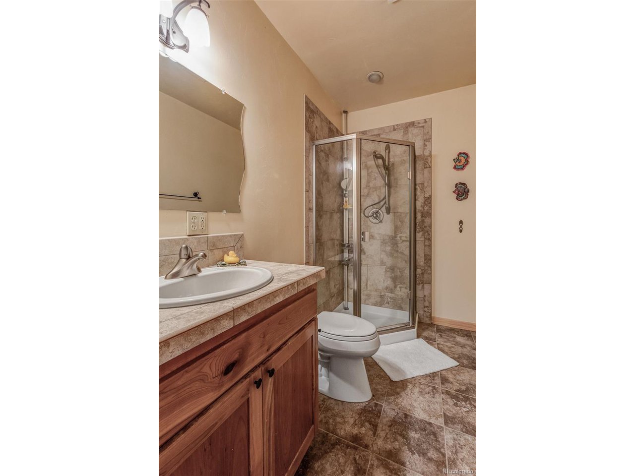 11677 Saddle Ridge Court Salida, CO 81201 - Photo 32 of 45 a bathroom with a sink toilet and shower