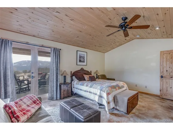 a bedroom with a bed with the view of living room
