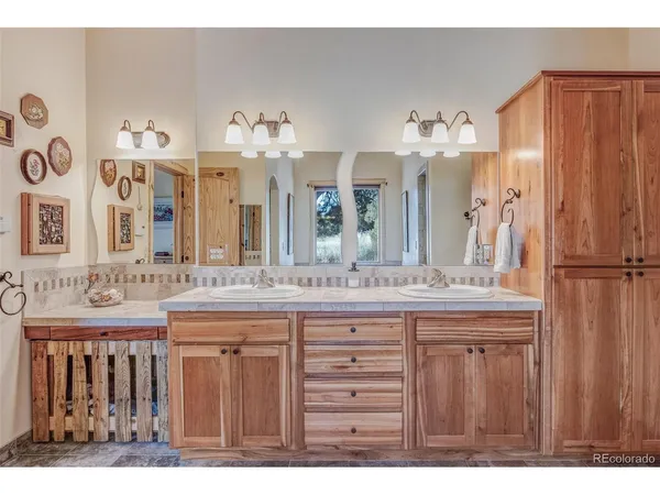 a bathroom with a sink double vanity and a mirror