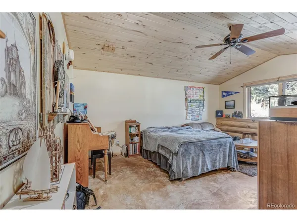 a living room with a bed furniture and a chandelier