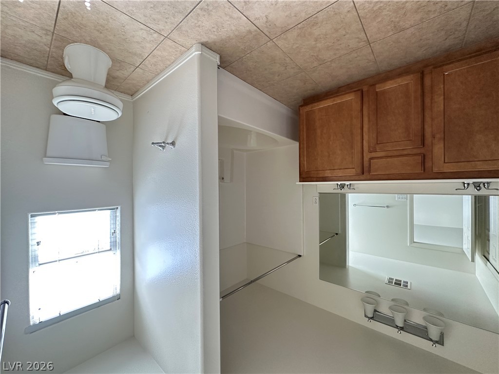 7305 Prussian Green Street Las Vegas, NV 89139 - Photo 10 of 23 A pristine bathroom featuring rich wood cabinetry and a vanity with abundant lighting.