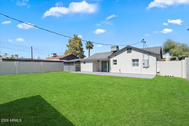 a view of a house with a yard and sitting area
