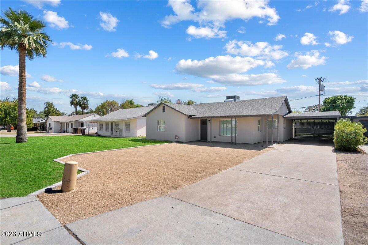 Undisclosed Address Phoenix, AZ 85013 - Photo 2 of 16 a front view of house with yard and green space