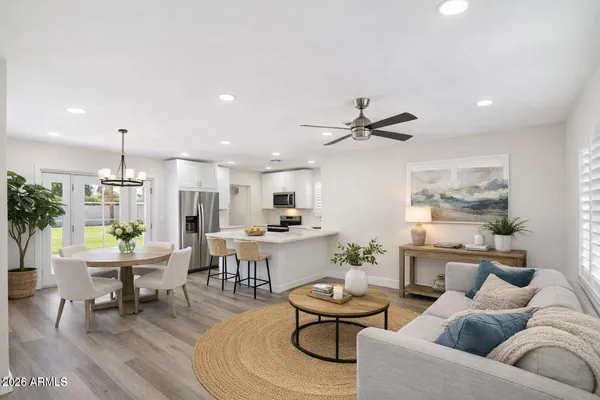 a living room with furniture kitchen and a table